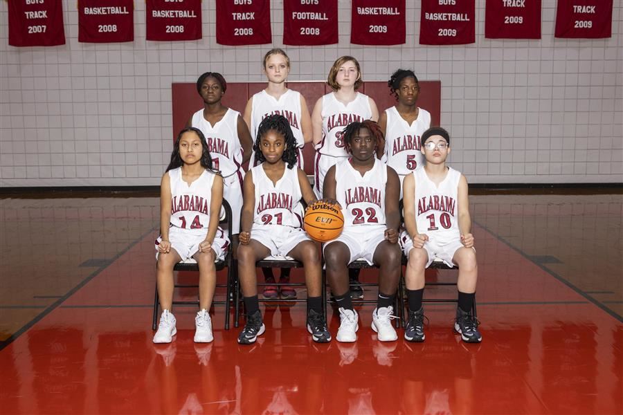 ASD JV Girls basketball team poses for team photo in the gym.